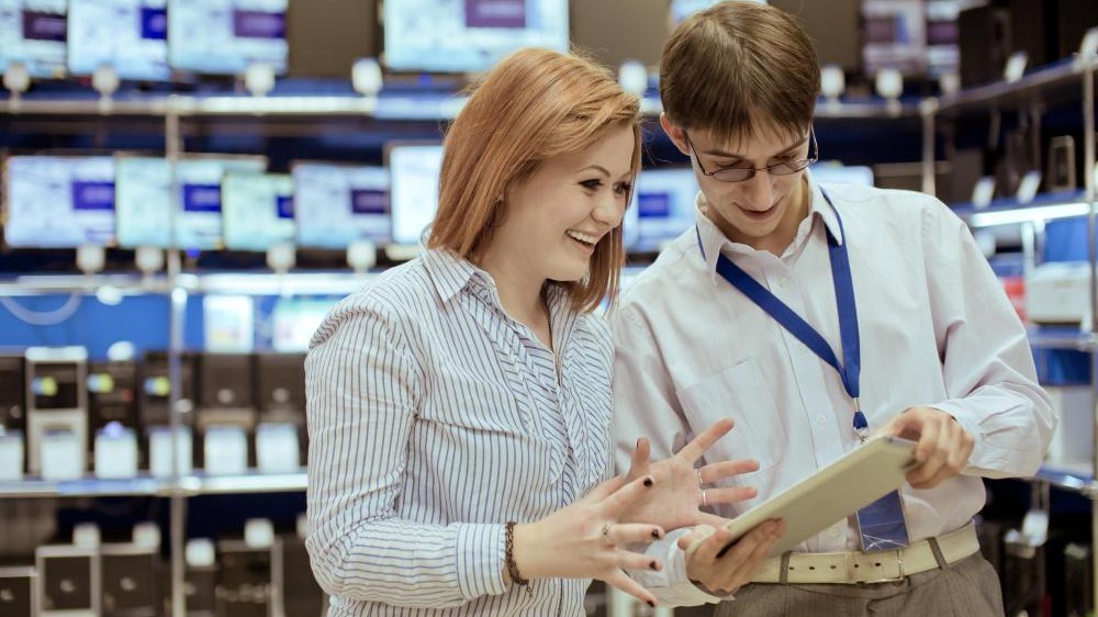 images/salesman-showing-tablet-to-woman-in-store.jpg